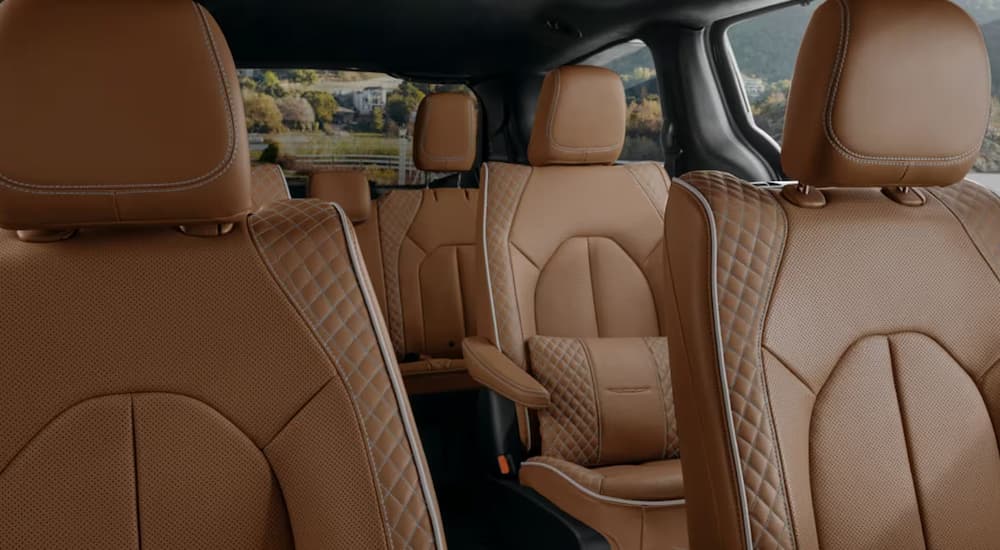 Three rows of stitched brown leather seating in a 2024 Chrysler Pacifica.