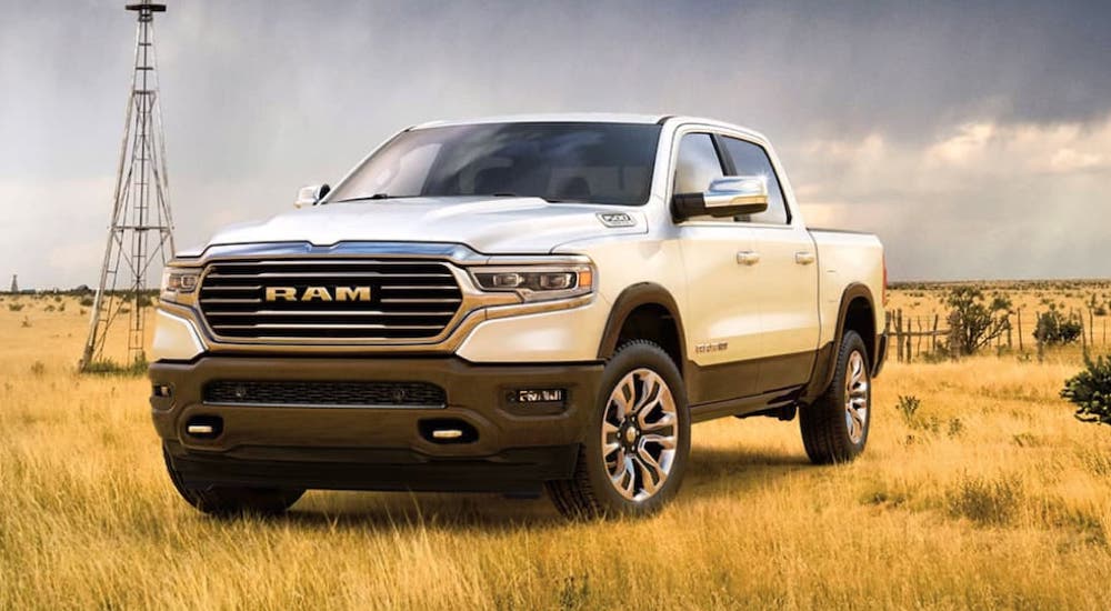 A white 2020 Ram 1500 Laramie Longhorn parked in the prairie.
