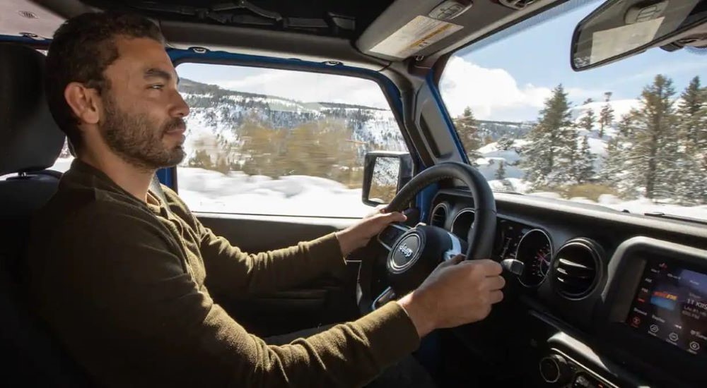 Interior view of a man driving a 2022 Jeep Gladiator.