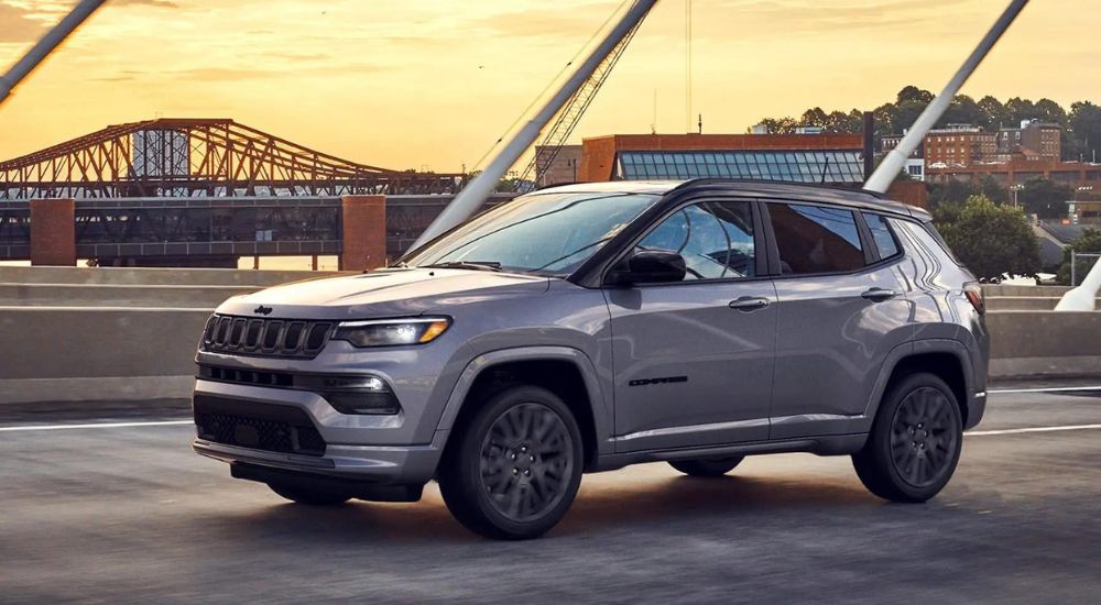 A silver 2022 Jeep Compass parked on a bridge.