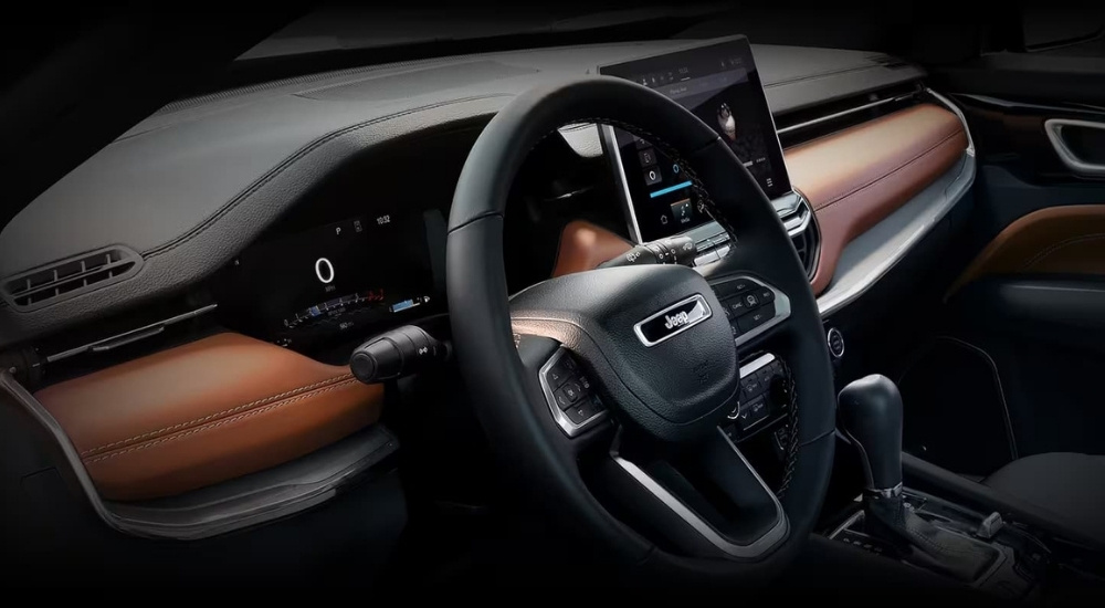 The black and brown interior and dash in a used 2024 Jeep Compass for sale.