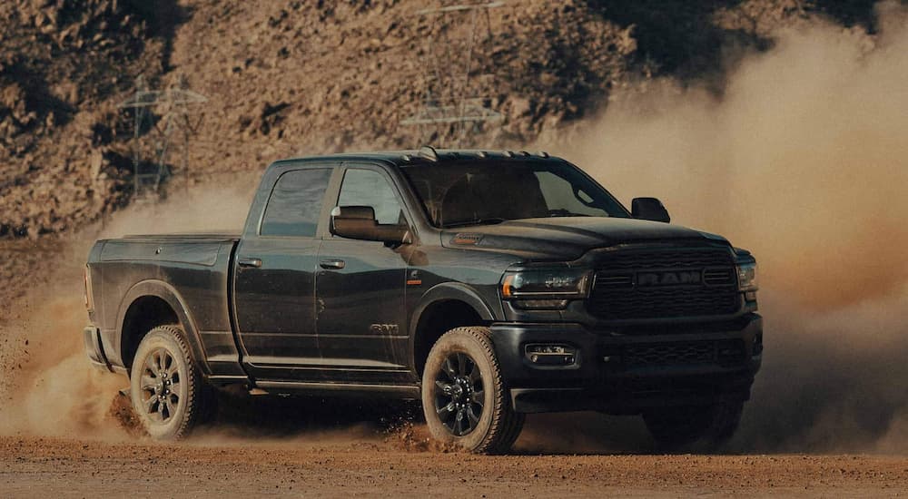Black 2022 Ram 2500 off-roading on a dusty trail