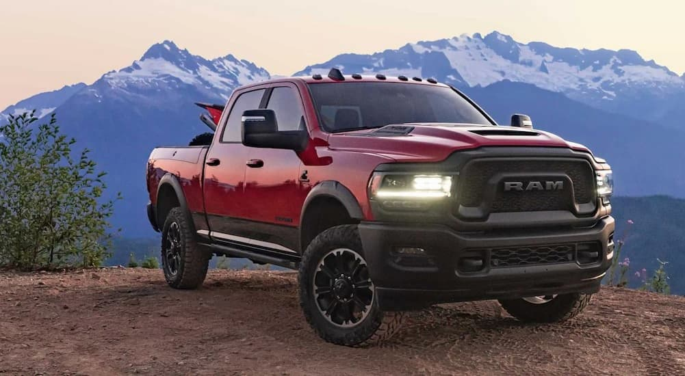 A used red 2023 Ram 2500 for sale is parked off-road.