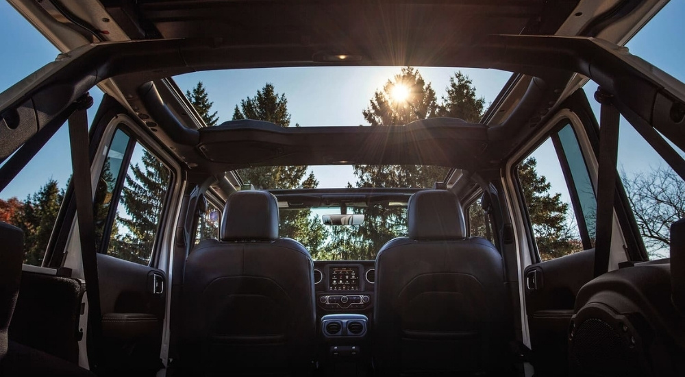 Interior and sunroof in a 2021 used Jeep Wrangler for sale.