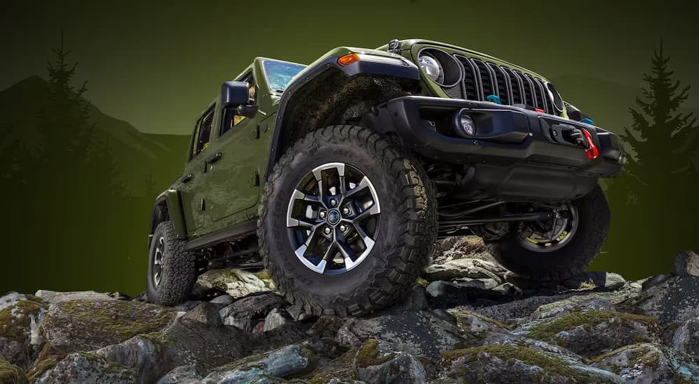 A green 2024 Jeep Wrangler parked off-road.