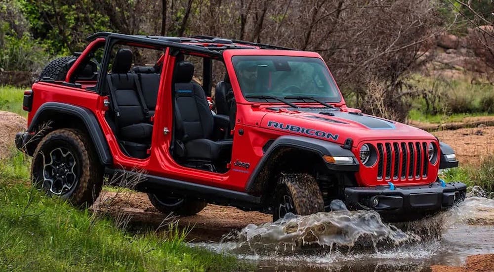 A red 2023 Jeep Wrangler from the side.