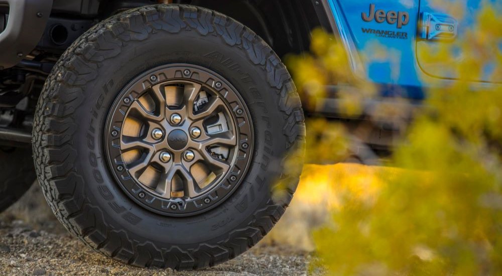 Rim and tire on a blue 2024 Jeep Wrangler Rubicon 392 for sale