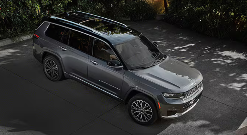 Silver 2025 Jeep Grand Cherokee L parked outside looking at a used Jeep for sale