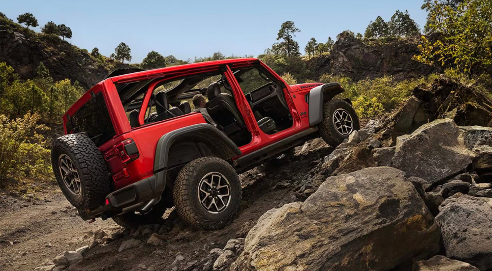 Used Red 2026 Jeep Wrangler Unlimited for sale driving off-road