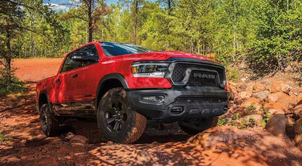 A red 2023 Ram 1500 off-roading.
