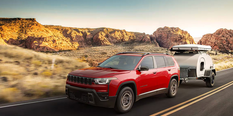 New red Jeep 2026 Cherokee with trailer.