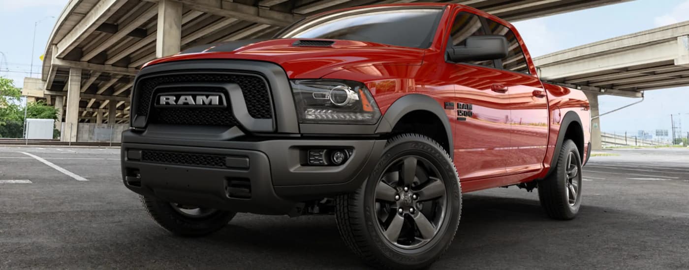 A red 2019 Ram 1500 Classic parked underneath a bridge.