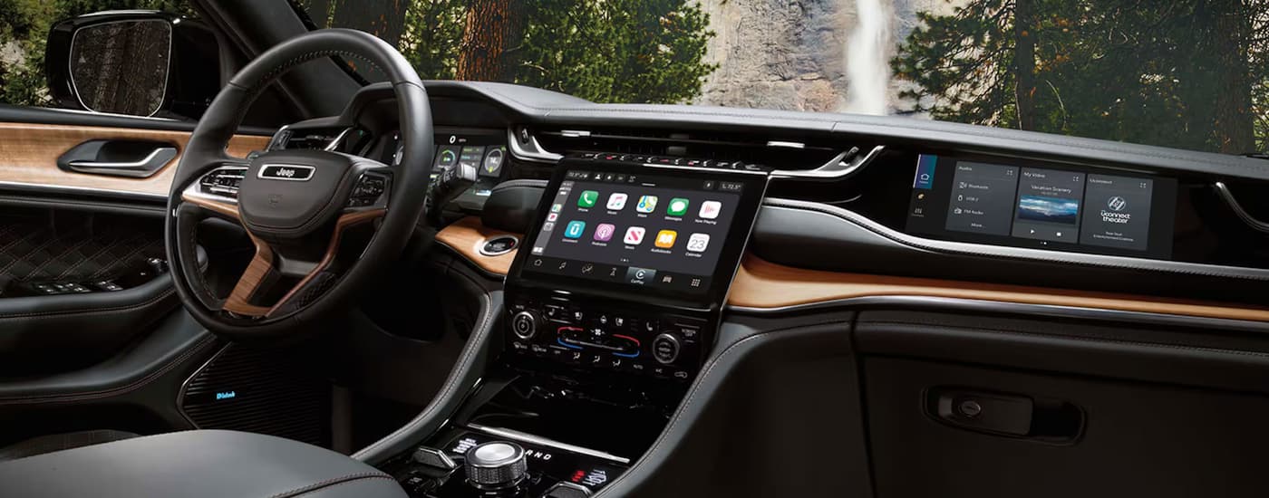 The black and brown dash inside of a 2025 Jeep Grand Cherokee for sale.