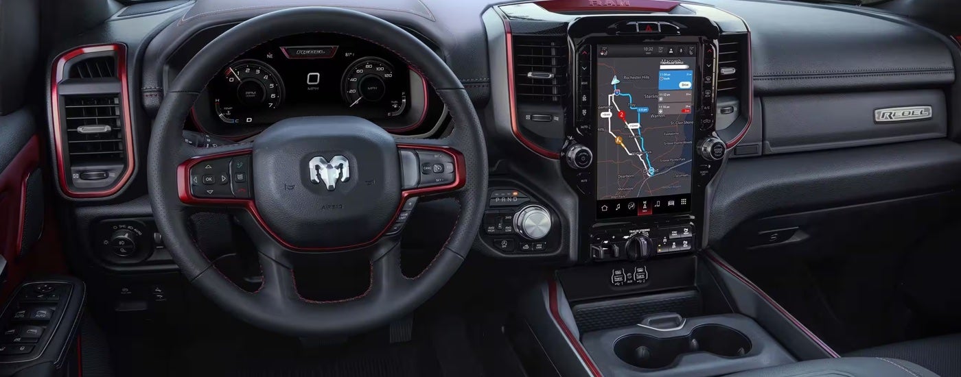 The black and red interior of a 2024 Ram 1500 Rebel at a used Ram dealership.